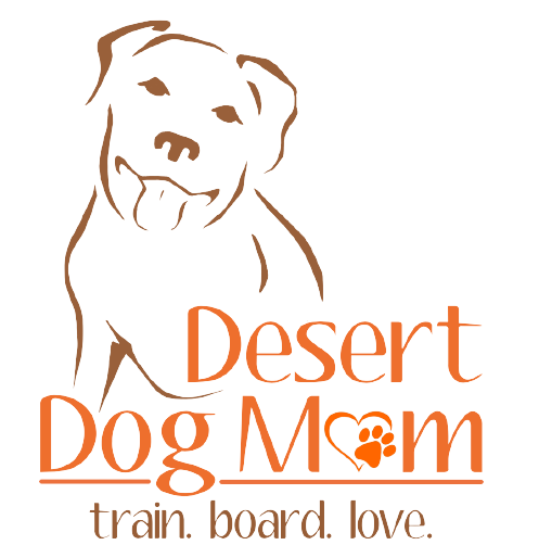 A dog that is sitting in front of the words desert dog mom.